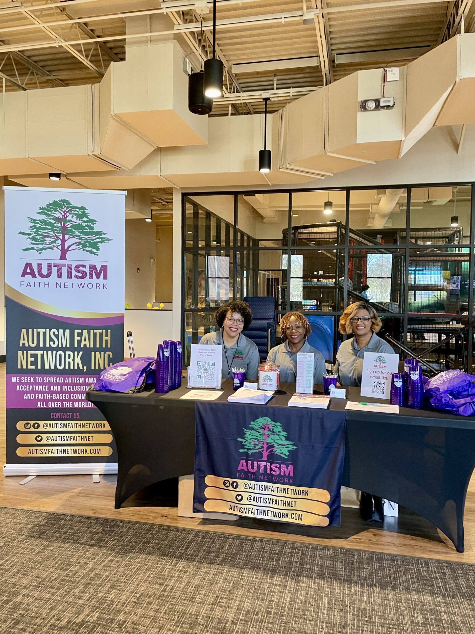IMG_7325 Autism Faith Network Board of Directors sitting at a table during a conference.